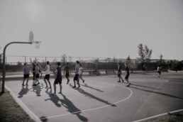 men playing basketball on an open air court